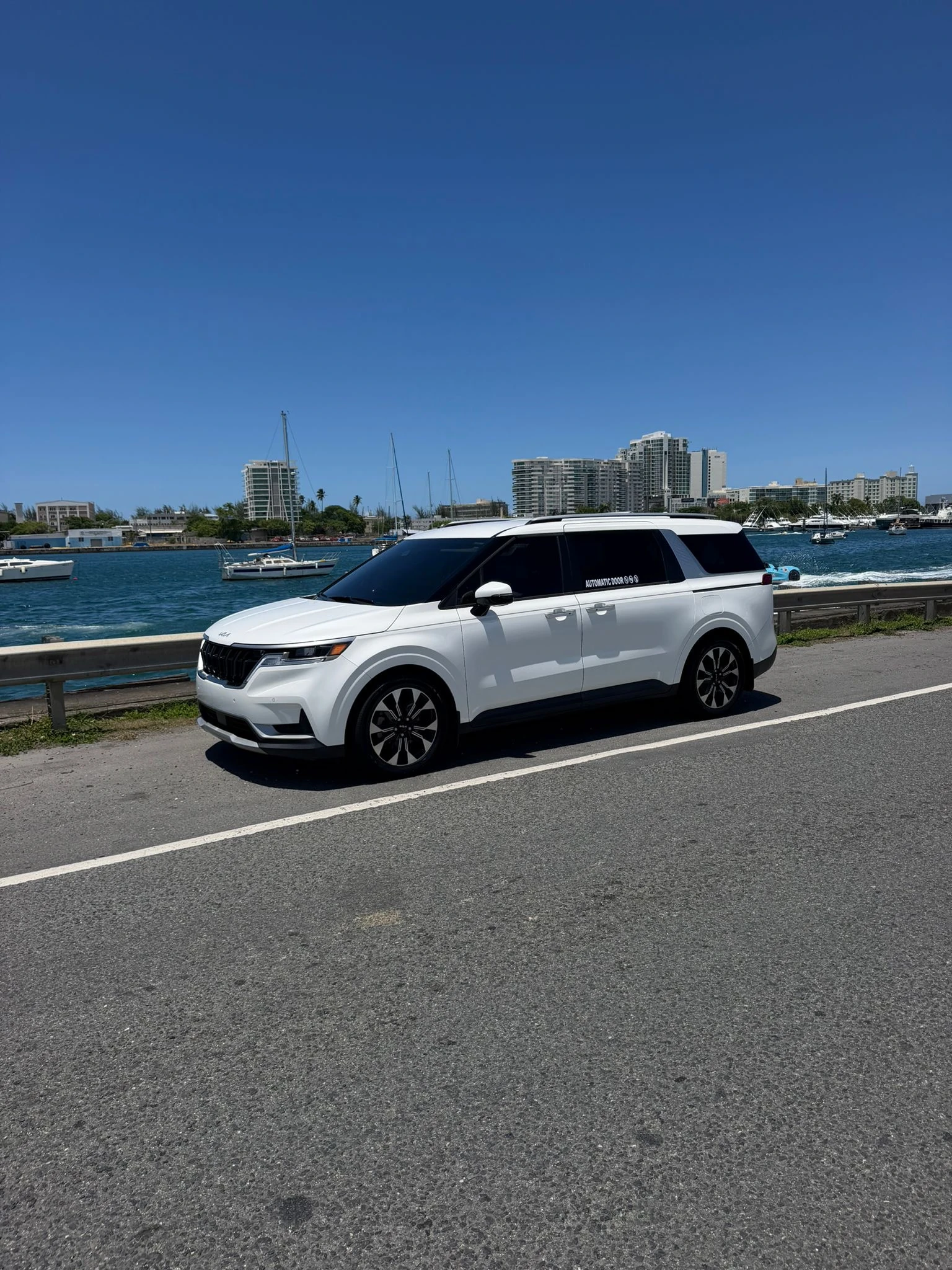 White Kia Carnival at the waterfront